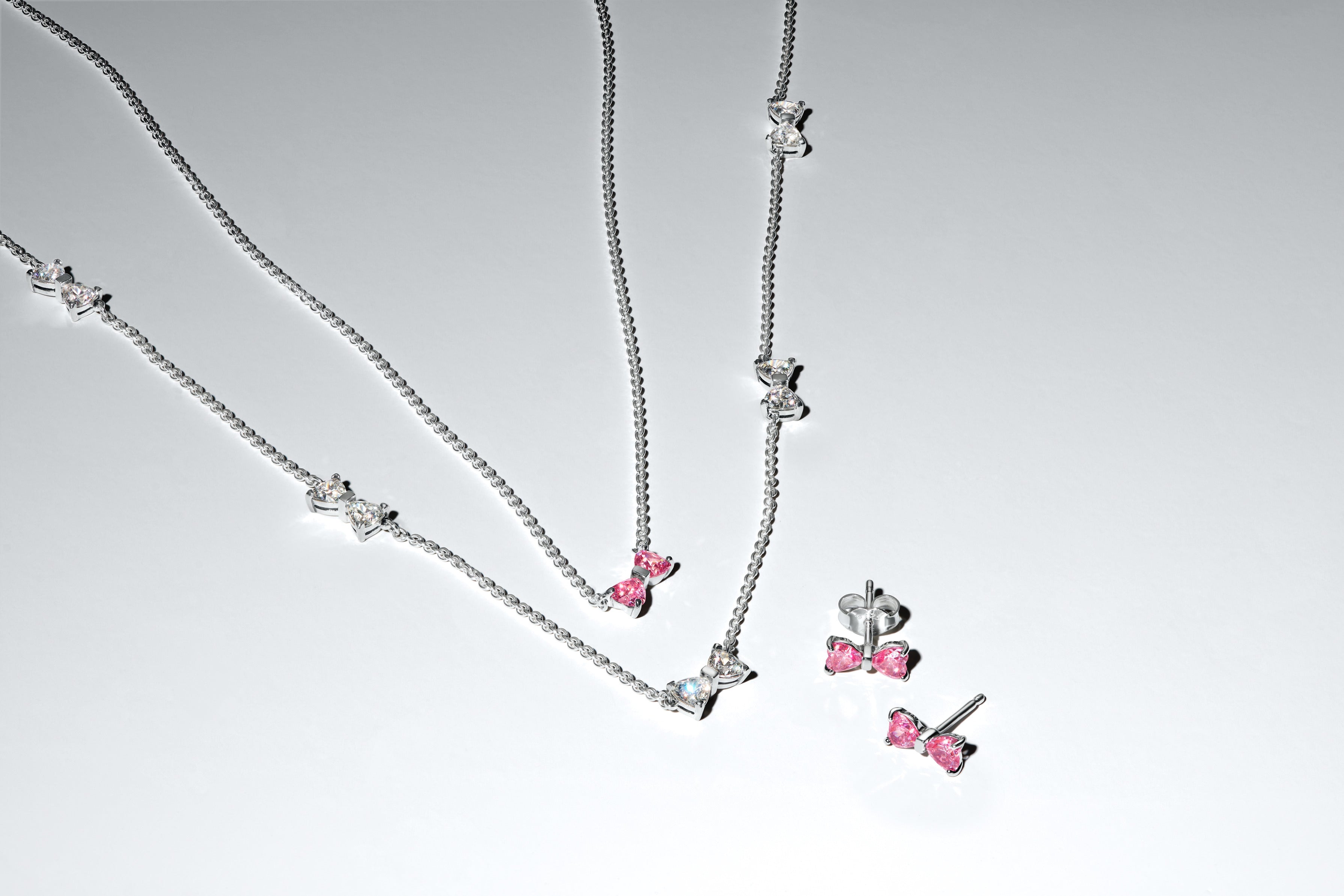 Bow Sterling Silver Stud Earrings With Fancy Pink And Clear Cubic Zirconia